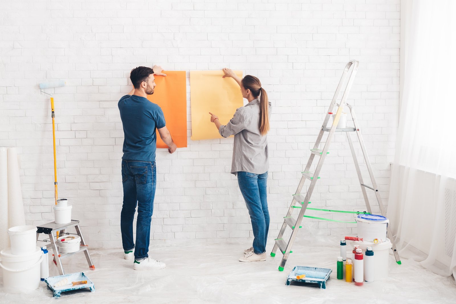 young-happy-couple-choosing-in-what-color-painting-their-new-house.jpg